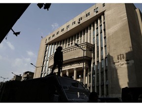 In this Nov. 8, 2017 file photo, Egyptian security officers guard a courthouse, in Cairo. Egypt has created a new high-powered human rights watchdog agency, but its primary mission isn't to protect Egyptians from violations. Instead, the body is primarily aimed at protecting the government from allegations of rights abuses, especially those made by international groups. The new body reflects an attitude of the state under President Abdel-Fattah el-Sissi that sees accusations of human rights violations to be intended to undermine the government and cause instability.