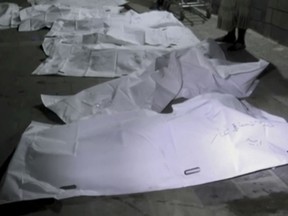 This Oct. 24, 2018 image made from Associated Press video, shows the bodies of victims of a Saudi-led coalition strike that killed at least 21 civilians, including children, at a fruit-and-vegetable market in the town of Bayt el-Faqih, near Hodeida, Yemen. Airstrikes by Saudi Arabia and its allies in Yemen are on a pace to kill more civilians in 2018 than last year despite US claims that the coalition is working to prevent such bloodshed, a database tracking violence shows. (AP Video via AP)