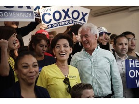 Republican gubernatorial candidate John Cox, center right, and Young Kim, a candidate running for a U.S. House seat in the 39th District in California, take a group photo with supporters during a campaign stop Saturday, Nov. 3, 2018, in Rowland Heights, Calif. California's gubernatorial candidates targeted Orange County on Saturday, a place where Democrats hope to turn over four congressional seats.