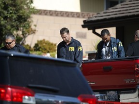 FBI agents leave the house of shooting suspect David Ian Long after conducting a search in Newbury Park, Calif., on Thursday, Nov. 8, 2018. Authorities said the former Marine opened fire at a country music bar in Southern California on Wednesday evening.