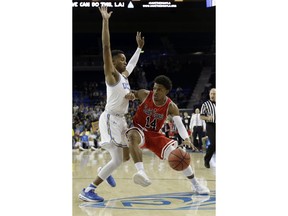 Saint Francis guard Andre Wolford (14) is defended by UCLA guard Jaylen Hands during the first half of an NCAA college basketball game Friday, Nov. 16, 2018, in Los Angeles.