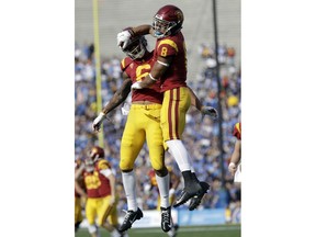 Southern California 's Amon-Ra St. Brown (8) celebrates his touchdown reception with teammate Michael Pittman Jr. during the first half of an NCAA college football game against UCLA, Saturday, Nov. 17, 2018, in Pasadena, Calif.