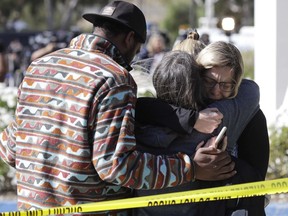 Mourners embrace outside of the Thousand Oaks Teen Center, where relatives and friends gathered in the aftermath of a mass shooting, Thursday, Nov. 8, 2018, in Thousand Oaks, Calif. Multiple people were shot and killed late Wednesday by a gunman who opened fire at the Borderline Bar & Grill, which was holding a weekly country music dance night for college students.