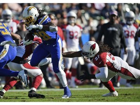 Los Angeles Chargers' Melvin Gordon (28) runs for a touchdown past Arizona Cardinals middle linebacker Josh Bynes (57) during the first half of an NFL football game Sunday, Nov. 25, 2018, in Carson, Calif.