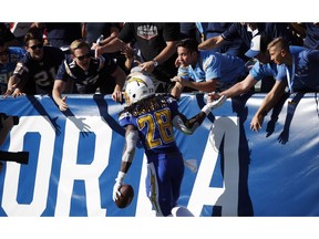 Los Angeles Chargers running back Melvin Gordon (28) celebrates his rushing touchdown with fans during the first half of an NFL football game against the Arizona Cardinals, Sunday, Nov. 25, 2018, in Carson, Calif.