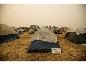 A sign hangs beside a tent at a makeshift shelter for evacuees of the Camp Fire in Chico, Calif., on Wednesday, Nov. 14, 2018.