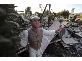 A lawn jockey stands in front of a home destroyed by the Woolsey Fire on Dume Drive in the Point Dume area of Malibu in Southern California Tuesday, Nov. 13, 2018.