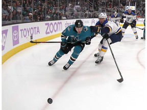 San Jose Sharks right wing Joonas Donskoi (27) chases down a puck against St. Louis Blues defenseman Jay Bouwmeester (19) during the first period of an NHL hockey game in San Jose, Calif., Saturday, Nov. 17, 2018.