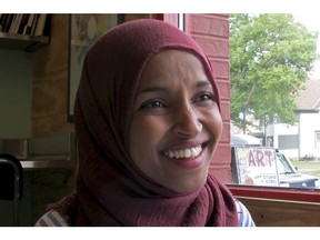 FILE - In this Aug. 16, 2018 file photo, Democrat Ilhan Omar, the nation's first Somali-American legislator who won her party's congressional primary in the race, talks during an interview at Peace Coffee in Minneapolis. Omar faces Republican candidate Jennifer Zielinski in the Nov 6 election.