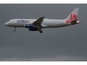 JetBlue's Red Sox-themed Plane arrives at the Luis Muñoz Marin airport with Manager Alex Cora, players, coaches and executive staff to celebrate the team's 2018 championship season victory, in Carolina, Puerto Rico, Saturday, Nov. 3, 2018.