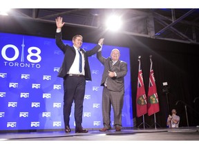 Federal Conservative Leader Andrew Scheer, left, is joined on stage by Ontario Premier Doug Ford after addressing the Ontario PC Convention in Toronto on Saturday, November 17, 2018.