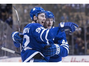 Toronto Maple Leafs' Igor Ozhiganov (92) celebrates with Morgan Rielly after scoring his team's second goal during second period NHL hockey action against the Boston Bruins, in Toronto on Monday, Nov. 26, 2018.