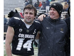 Colorado head coach Mike MacIntyre, right, congratulates his son, wide receiver Jay MacIntyre, during a senior day ceremony before the first half of an NCAA college football game against Utah, Saturday, Nov. 17, 2018, in Boulder, Colo.