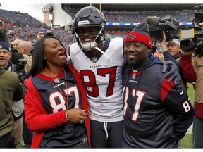 Houston Texans wide receiver Demaryius Thomas (87) stands with his parents, Bobby Thomas, right, and Katina Smith, prior to an NFL football game against the Denver Broncos, Sunday, Nov. 4, 2018, in Denver.