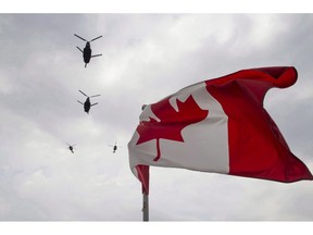 Canadian Forces CH-47 Chinooks participate in a flyover of Parliament Hill in Ottawa on Friday, May 9, 2014. The federal auditor general is taking the military to task for not supporting victims of sexual misconduct.