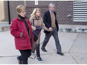 Dennis Oland, right, his wife Lisa and mother Connie, left, arrive at Harbour Station arena in Saint John, N.B., on Monday, Oct. 15, 2018 for jury selection in the retrial in the bludgeoning death of his millionaire father, Richard Oland. The family of both murder victim Richard Oland and his accused killer, Dennis Oland, say they are steadfast in their support for Dennis as he faces retrial for the second degree murder of his father.
