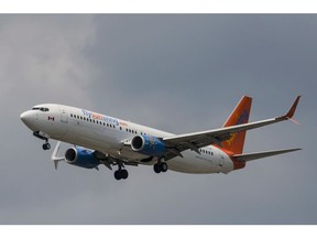 A Sunwing Boeing 737-800 passenger plane prepares to land at Pearson International Airport in Toronto on Wednesday, August 2, 2017. A jet operated by Sunwing Airlines Inc. struck a 36-centimetre-high light beyond the runway and flew low for four kilometres after a pilot typed in the wrong temperature, which investigators said could have caused a crash and "multiple fatalities."
