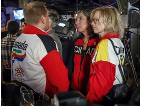 Dave King, left, Linda King, right, son and daughter of Frank King, wearing 1988 Calgary Olympic jackets react to the results of a plebiscite on whether the city should proceed with a bid for the 2026 Winter Olympics, in Calgary, Alta., Tuesday, Nov. 13, 2018. Calgary city council has hammered the final nail in the coffin of a bid for the 2026 Winter Olympics and Paralympic Games.