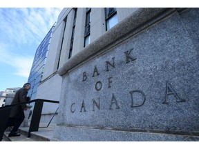 Bank of Canada Governor Stephen Poloz returns to the Bank of Canada after holding a press conference at the National Press Theatre in Ottawa on Wednesday, Oct. 24, 2018. The Bank of Canada is releasing data today that provide a closer look at just how much the combination of stricter mortgage rules and higher interest rates have helped lower the number of deeply indebted households.