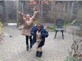 A screengrab from video shows two Eritrean children reacting gleefully to their first Canadian snowfall. A woman who shared a video says the overwhelming reaction to the clip is reaffirming her faith in the country as a welcoming place for newcomers. THE CANADIAN PRESS/HO-Rebecca Davies MANDATORY CREDIT