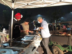 Paul Klyne of Penticton, B.C., helps with an impromptu kitchen for wildfire evacuees in Chico, Calif., in this recent handout photo.