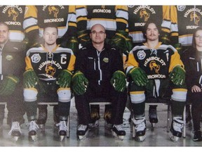 Head coach and general manager Darcy Haugan, centre, is shown in team photo of the 2016/2017 Humboldt Broncos hockey team as it hangs in Elgar Petersen Arena in Humboldt, Sask., on April 7, 2018. A southern Saskatchewan Bible college is honouring the memory of the coach of the Humboldt Broncos who died in crash of the team bus last April. Darcy Haugan wore jersey No. 22 when he was a star player with the Briercrest College Clippers in the late 1990s. That number is to be retired Friday night during a ceremony in Caronport as part of the college's alumni weekend.