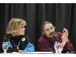 The Athabasca Chipewyan First Nation is hoping to intervene before the Saskatchewan Court of Appeal in support of the federal government's plans to implement a national price on carbon. Jane Fonda watches as Athabasca Chipewyan First Nation Chief Allan Adam speaks during a press conference for indigenous rights, in Edmonton on Wednesday, Jan. 11, 2017.