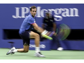 Vasek Pospisil, of Canada, hits a return to Rafael Nadal, of Spain, during the second round of the U.S. Open tennis tournament Wednesday, Aug. 29, 2018, in New York. Canadian tennis player Vasek Pospisil is ready to take his singles game to the next level. He just needs his wonky back to co-operate.
