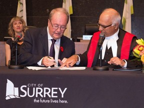 Surrey Mayor Doug McCallum, left, is sworn in during an inauguration ceremony in Surrey, B.C. on Monday, November 5, 2018 in this handout photo.