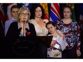 Supporters of a scientist who fears political retribution if deported to Russia say she has been granted a temporary reprieve. Elizabeth May, Leader of the Green Party, speaks at a press conference in the case of Dr. Elena Musikhina, middle back, who holds her granddaughter Iaroslava Sunatori, 8, in Ottawa on Tuesday, Oct. 30, 2018.