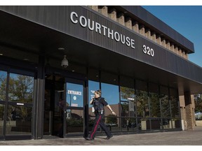 A police officer arrives at the provincial court building in Lethbridge, Alta., on September 23, 2015. A southern Alberta man accused of sexually abusing teen girls says he will take the stand in his own defence. Trevor Pritchard of Coaldale faces charges of sexual assault, child luring and possession of child pornography.