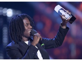 Daniel Caesar holds up his Juno award for R and B Soul Recording of the Year at the Juno Awards in Vancouver, Sunday, March, 25, 2018.