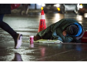 A homeless person is seen in downtown Toronto, on Wednesday, January 3, 2018. The federal Liberals have unveiled their long-promised anti-poverty law, saying it will force future governments to follow through on ambitious targets to lift more than two million people above the poverty line in the coming years.