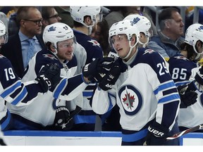 Winnipeg Jets' Patrik Laine (29), of Finland, is congratulated by Brendan Lemieux after scoring during the second period of an NHL hockey game against the St. Louis Blues, Saturday, Nov. 24, 2018, in St. Louis. A five-goal performance by the Winnipeg Jets' Patrik Laine on the weekend has netted a Winnipeg man a $1 million prize.