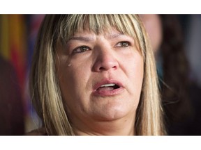 A tear rolls down the cheek of Bernadette Smith, from Winnipeg as she talks about the Missing and Murdered Indigineous Women inquiry Tuesday December 8, 2015 on Parliament Hill in Ottawa. Manitoba's child apprehension laws will be amended so that no child can be seized solely because of poverty.