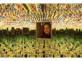 A woman looks at Yayoi Kusama's "Love Forever," part of the "Yayoi Kusama: Infinity Mirrors," exhibition at the Art Gallery of Ontario in Toronto on Tuesday, February 27, 2018. The Art Gallery of Ontario wants the success of its recent Infinity Mirrors exhibit to go on, and on, and on - and so it's turning to fans of last spring's showcase to help it buy an Infinity Mirrors Room for its permanent collection.