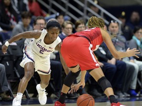 Connecticut's Crystal Dangerfield (5) attempts a steal against Ohio State's Adreana Miller (15) in the first half of a women's NCAA college basketball game, Sunday, Nov. 11, 2018, in Storrs, Conn.