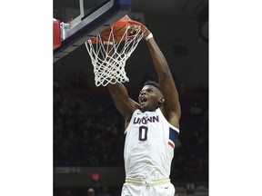 Connecticut's Eric Cobb (0) dunks against UMKC in the second half of an NCAA college basketball game, Sunday, Nov. 11, 2018, in Storrs, Conn.