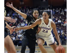 Connecticut's Napheesa Collier (24) drives around Vanderbilt's Chelsie Hall (2) during the first half of an NCAA college basketball game, Saturday, Nov. 17, 2018, in Uncasville, Conn.