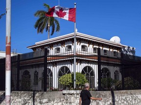 A man walks beside Canada's embassy in Havana, Cuba, Tuesday, April 17, 2018.