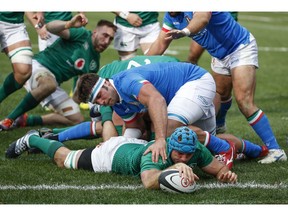 Ireland's Tadhg Beirne, bottom, scores against Italy's Marco Fuser, top, during the first half of a rugby match Saturday, Nov. 3, 2018, in Chicago.