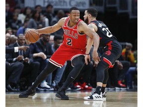 Chicago Bulls forward Jabari Parker, left, is defended by Toronto Raptors guard Fred VanVleet, right, during the first half of an NBA basketball game, Saturday, Nov. 17, 2018, in Chicago.