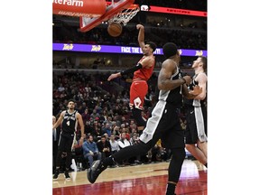 Chicago Bulls guard Zach LaVine (8) dunks the ball against the San Antonio Spurs during the first half of an NBA basketball game Monday, Nov. 26, 2018, in Chicago.