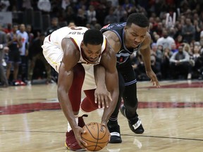 Cleveland Cavaliers forward/center Tristan Thompson, left, battles for a loose ball against Chicago Bulls center Wendell Carter Jr., during the second half of an NBA basketball game Saturday, Nov. 10, 2018, in Chicago. The Bulls won 99-98.