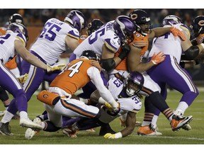 Chicago Bears linebacker Leonard Floyd (94) tackles Minnesota Vikings running back Dalvin Cook (33) during the first half of an NFL football game Sunday, Nov. 18, 2018, in Chicago.