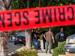 FBI agents collect evidence at the home of suspected nightclub shooter Ian David Long in Thousand Oaks, Calif., on Nov. 8, 2018. The suspect was found dead at the scene of the attack on the Borderline Bar and Grill.