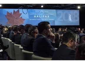 Delegates and reporters attend the Halifax International Security Forum in Halifax on Saturday, Nov. 17, 2018.