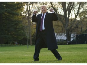 President Donald Trump gestures as he walks to Marine One after speaking to media at the White House in Washington, Tuesday, Nov. 20, 2018, for the short trip to Andrews Air Force Base en route to Palm Beach International Airport, in West Palm Beach, Fla., and on to and onto Mar-a-Lago.