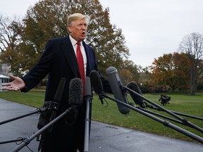President Donald Trump talks with reporters before departing for France on the South Lawn of the White House, Friday, Nov. 9, 2018, in Washington.