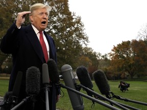 President Donald Trump talks to the media before boarding Marine One on the South Lawn of the White House, Friday, Nov. 9, 2018, in Washington.